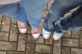 Picture looking down to different pairs of sneakers